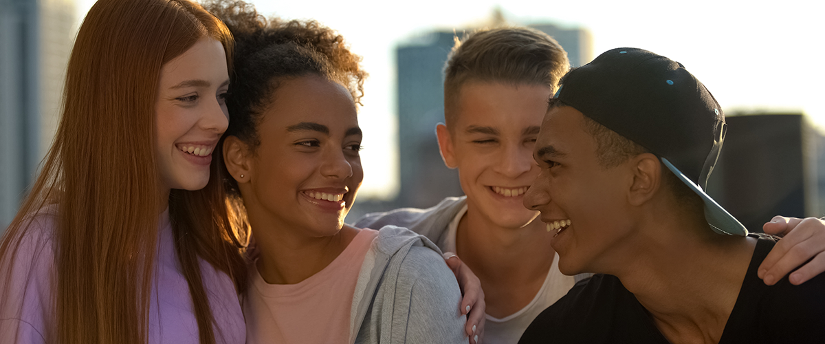 Joyful multi-racial group of young people enjoying friendship unity, having fun.