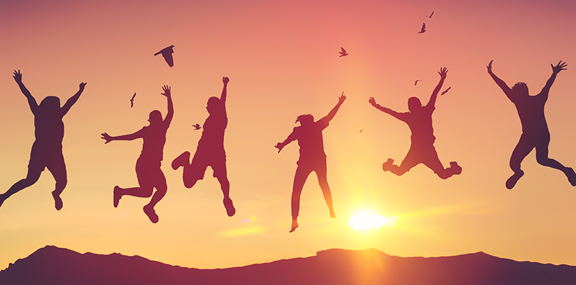 Silhouette of a group of people jumping