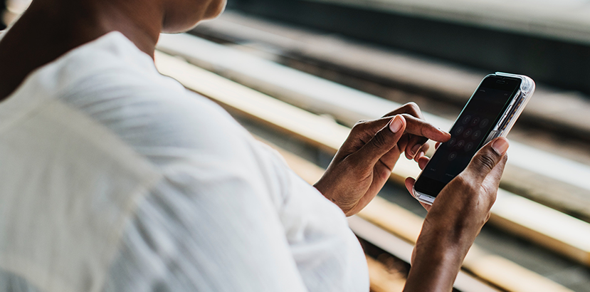 Hands of a woman using a cellphone.