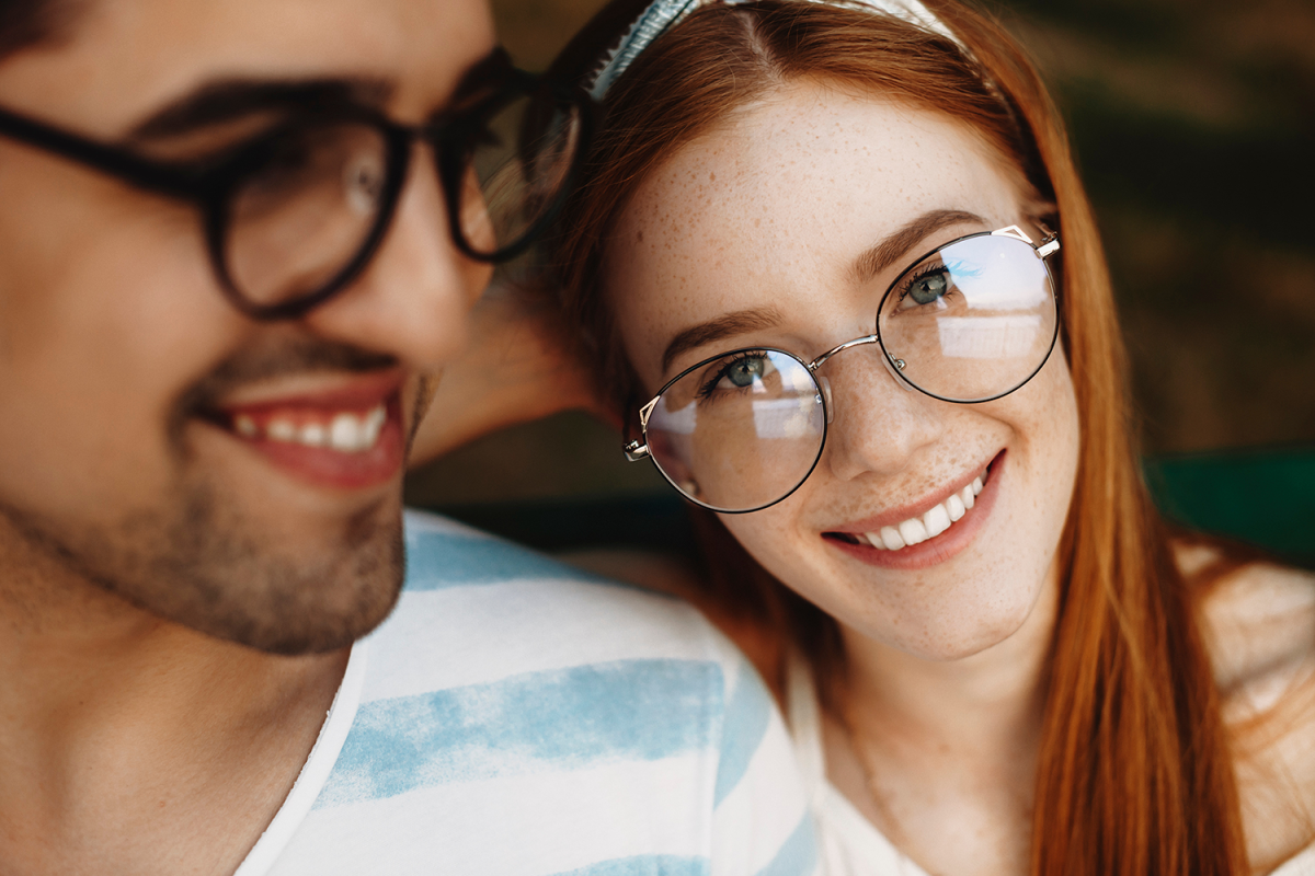 A couple (man and woman) smiling.